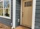 Close-up of a front door and a side window of a house with gray siding at 4049 Port Richmond Ave # 10, Gastonia, NC 28056