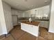 Bright kitchen featuring white cabinets, a center island, and modern appliances at 4049 Port Richmond Ave # 10, Gastonia, NC 28056