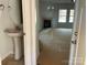 A half-bathroom next to an unfurnished living room with a fireplace and plenty of natural light at 4049 Port Richmond Ave # 10, Gastonia, NC 28056
