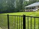 Spacious backyard featuring lush green grass and a black fence, perfect for outdoor activities and relaxation at 408 Emerald Bay Dr, Salisbury, NC 28146