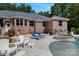 Backyard patio area with outdoor seating, lounge chairs, a hot tub, and a glimpse of the home's exterior at 408 Emerald Bay Dr, Salisbury, NC 28146