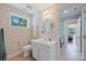Charming bathroom featuring a window, floral wallpaper, vanity, toilet, and tiled floor at 408 Emerald Bay Dr, Salisbury, NC 28146