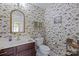 A half bath with floral wallpaper, a cherry vanity, and a gilded mirror at 408 Emerald Bay Dr, Salisbury, NC 28146