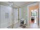 Well-lit bathroom showcasing a glass-enclosed shower and adjacent doorway leading to a bedroom at 408 Emerald Bay Dr, Salisbury, NC 28146