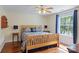 Bright bedroom with hardwood floors, a wooden bed, side tables, and a window with a view at 408 Emerald Bay Dr, Salisbury, NC 28146