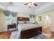 This bedroom features a tray ceiling, ceiling fan, and large windows with decorative cornices at 408 Emerald Bay Dr, Salisbury, NC 28146