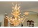 Close-up of a decorative gold chandelier with crystal accents, adding a touch of elegance at 408 Emerald Bay Dr, Salisbury, NC 28146