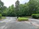 Gated community entrance with mature trees and landscaping for a private and secure environment at 408 Emerald Bay Dr, Salisbury, NC 28146