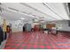 Spacious garage featuring a checkered floor, overhead lighting, and ample storage and grilling space at 408 Emerald Bay Dr, Salisbury, NC 28146