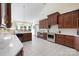 This open concept kitchen features professional grade appliances and dark wood cabinets at 408 Emerald Bay Dr, Salisbury, NC 28146