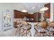 Bright kitchen with dark wood cabinets, stainless steel appliances, and a white countertop bar with seating at 408 Emerald Bay Dr, Salisbury, NC 28146