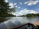 Scenic view of the lake from a deck with lush green trees lining the shore at 408 Emerald Bay Dr, Salisbury, NC 28146