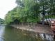 Picturesque lakefront property with mature trees, rocky shoreline and views of the lake at 408 Emerald Bay Dr, Salisbury, NC 28146