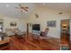 Open-concept living room featuring hardwood floors, a high ceiling, and a large television at 408 Emerald Bay Dr, Salisbury, NC 28146