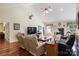 Comfortable living room with hardwood floors, a fireplace, comfortable seating, and a ceiling fan at 408 Emerald Bay Dr, Salisbury, NC 28146