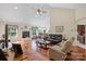 Open living room with hardwood floors, comfortable seating, fireplace, and abundant natural light at 408 Emerald Bay Dr, Salisbury, NC 28146