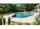 Landscaped backyard with in-ground pool, spa, and greenery at 408 Emerald Bay Dr, Salisbury, NC 28146