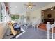 A tiled sunroom with bright wicker seating and a view to the lush landscaping at 408 Emerald Bay Dr, Salisbury, NC 28146