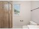 Bathroom shows window, toilet, tiled shower, and chrome towel bar at 4368 Yoruk Forest Ln, Charlotte, NC 28211
