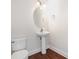 Bathroom with a pedestal sink, a toilet, and wood floors at 4368 Yoruk Forest Ln, Charlotte, NC 28211