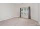 Bedroom showcasing window, carpeted floor, trim, and natural light at 4368 Yoruk Forest Ln, Charlotte, NC 28211