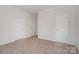 Bedroom with neutral color palette, carpeted floors, and bright, natural light at 4368 Yoruk Forest Ln, Charlotte, NC 28211