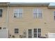 Rear exterior of the home featuring multiple windows, a back door, and an outdoor AC unit at 4368 Yoruk Forest Ln, Charlotte, NC 28211