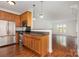 Open kitchen with stainless steel appliances, granite countertops, and wood cabinets at 4368 Yoruk Forest Ln, Charlotte, NC 28211