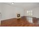 Spacious living room features a fireplace and wood floors at 4368 Yoruk Forest Ln, Charlotte, NC 28211