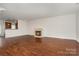 Open living room with a fireplace, and views into the kitchen at 4368 Yoruk Forest Ln, Charlotte, NC 28211