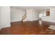Open-concept living room featuring hardwood flooring, staircase, and easy access to the kitchen at 4368 Yoruk Forest Ln, Charlotte, NC 28211