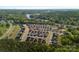 Aerial view of the neighborhood shows a wooded area with winding roads that lead to the houses and a lake at 4532 Stellata Loop, Sherrills Ford, NC 28673