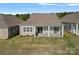 Back of the neutral home with a covered porch and chairs is shown from an aerial view in the daytime at 4532 Stellata Loop, Sherrills Ford, NC 28673