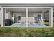 Covered back porch has chairs and a couch that provides a nice relaxation area with plenty of light at 4532 Stellata Loop, Sherrills Ford, NC 28673