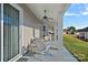 Covered porch with nice chairs, ceiling fan, and gray-painted floor to match the neutral exterior at 4532 Stellata Loop, Sherrills Ford, NC 28673