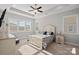 Cozy bedroom boasts natural light from many windows and elegant neutral decor at 4532 Stellata Loop, Sherrills Ford, NC 28673