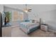 Bright bedroom boasts ceiling fan, carpet, and a large window at 4532 Stellata Loop, Sherrills Ford, NC 28673