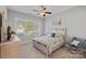 Cozy bedroom with a large window, neutral color palette, and comfortable furnishings, creating a relaxing atmosphere at 4532 Stellata Loop, Sherrills Ford, NC 28673