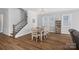 Dining area adjacent to stairs and a window with modern farmhouse chandelier at 4532 Stellata Loop, Sherrills Ford, NC 28673