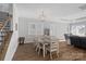 Open-concept dining area with modern light fixture adjacent to the living room at 4532 Stellata Loop, Sherrills Ford, NC 28673