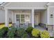 Inviting front porch featuring classic white rocking chairs and decorative stone accents on the facade at 4532 Stellata Loop, Sherrills Ford, NC 28673