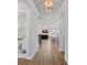 Bright hallway with wood floors leading to an open-concept living space and a modern kitchen at 4532 Stellata Loop, Sherrills Ford, NC 28673
