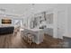 Open-concept kitchen with an island, stainless steel appliances, and seamless flow to the living area at 4532 Stellata Loop, Sherrills Ford, NC 28673