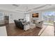 Spacious living room with a tray ceiling, ample seating, and natural light, perfect for relaxation and entertaining at 4532 Stellata Loop, Sherrills Ford, NC 28673