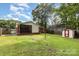 Expansive backyard featuring a screened porch, storage shed, and ample space for outdoor activities and relaxation at 4915 Galax Dr, Charlotte, NC 28213