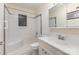 Bathroom featuring a shower-tub combination with tiled surround, updated fixtures, and window at 4915 Galax Dr, Charlotte, NC 28213
