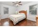 Bedroom with wood floors, ceiling fan, and a large window providing natural light at 4915 Galax Dr, Charlotte, NC 28213