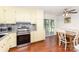 Eat-in kitchen featuring stainless appliances, light yellow cabinets, and sliding door access to the screened porch at 4915 Galax Dr, Charlotte, NC 28213
