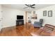 Open-concept living room with hardwood floors, a fireplace, and a view into the kitchen at 4915 Galax Dr, Charlotte, NC 28213