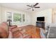 Inviting living room featuring hardwood floors, a ceiling fan, and large windows at 4915 Galax Dr, Charlotte, NC 28213